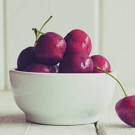 Red Cherries In White Bowl by Danielle Donders