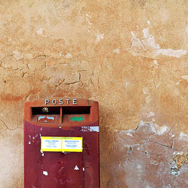 Red Italian  mailbox on ochre wall by Sami Sarkis Photography