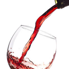 Red Wine Pouring into wineglass splash by Dustin K Ryan