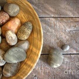 Spa rocks in wooden bowl on rustic wood by Sandra Cunningham