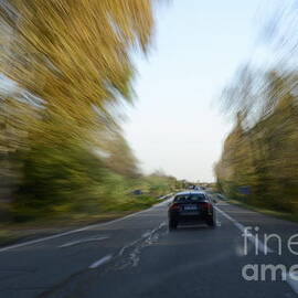 Speeding car on highway by Sami Sarkis Photography