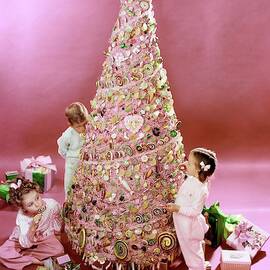 Three Children Eating A Candy Christmas Tree by Herbert Matter