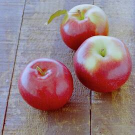 Three Red Apples by Romulo Yanes