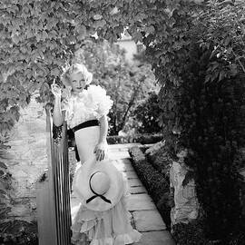 Toby Wing Standing In A Garden Gateway by George Hoyningen-Huene