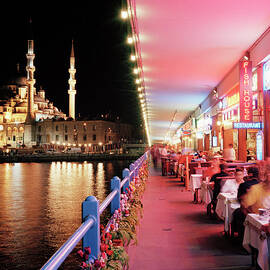 Tourists Dining Along Galata Bridge At by Gary Yeowell