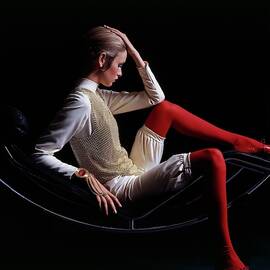 Twiggy Sitting On A Modern Chair by Bert Stern