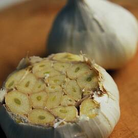 Two Heads Of Garlic by Romulo Yanes