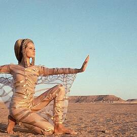 Veruschka Von Lehndorff Posing In A Desert by Franco Rubartelli
