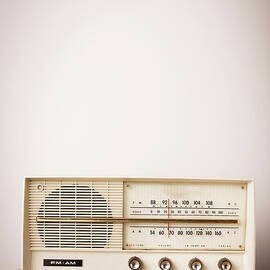 Vintage Beige Radio Sitting On Wood by Ideabug