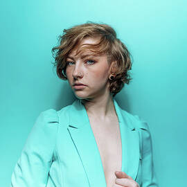 Woman In Blue Jacket On Blue Background by Ian Ross Pettigrew