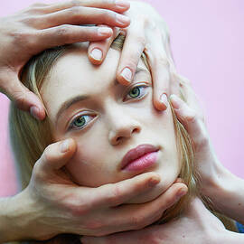 Woman With Hands On Face by Tara Moore