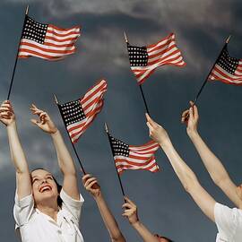 Young Women Waving American Flags by Roger Kahan