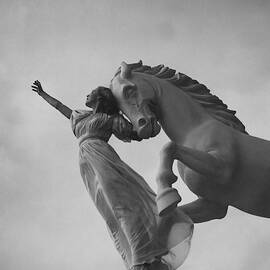 Zorina With A Horse Statue by Toni Frissell