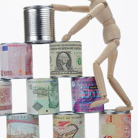 Mannequin climbing tin cans pyramid by Sami Sarkis Photography