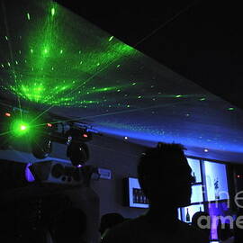 People dancing and light effects in discotheque by Sami Sarkis Photography