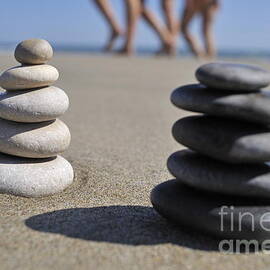 Stack of pebbles on beach by Sami Sarkis Photography