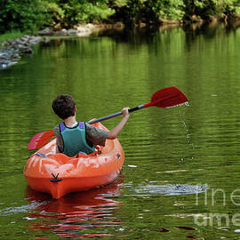Boy kayaking in river by Sami Sarkis Photography