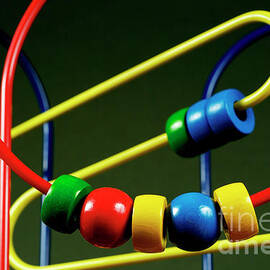 Colourful toy abacus with bright beads by Sami Sarkis Photography