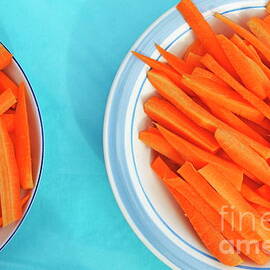 Cutted carrots on table by Sami Sarkis Photography