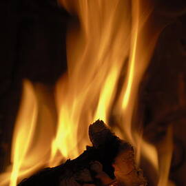 Flames of burning fire in fireplace by Sami Sarkis Photography