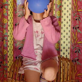 Girl blowing up balloon by Sami Sarkis Photography