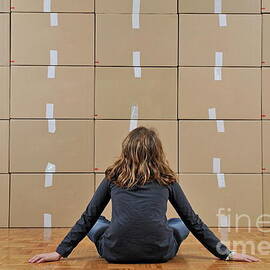 Girl seated in front of cardboard boxes by Sami Sarkis Photography