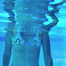 Girl torso underwater reflected by pool surface by Sami Sarkis Photography
