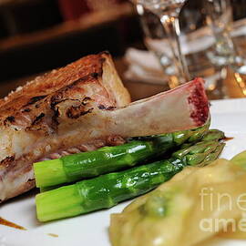 Grilled beef rib on asparagus with potatoes by Sami Sarkis Photography