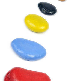 Line of multi-colored pebbles by Sami Sarkis Photography