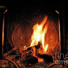 Log fire in chimney by Sami Sarkis Photography