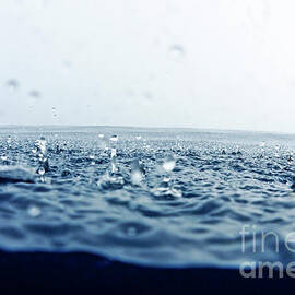 Rain drops falling into ocean by Sami Sarkis Photography