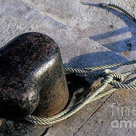 Rope tied around bollard by Sami Sarkis Photography