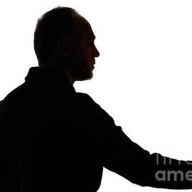 Silhouette of mature man holding rose by Sami Sarkis Photography