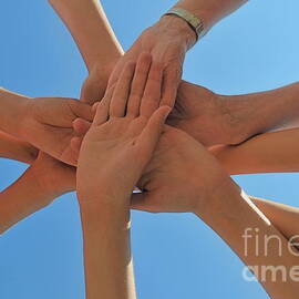 Six people stacking their hands  by Sami Sarkis Photography