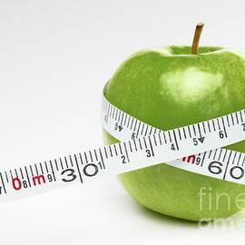 Tape measure round green apple by Sami Sarkis Photography