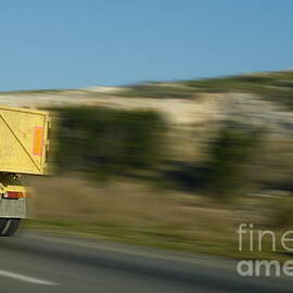 Truck speeding on highway by Sami Sarkis Photography