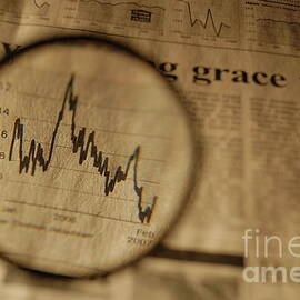 View of graph in newspaper trough magnifying glass by Sami Sarkis Photography