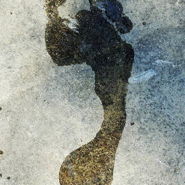 Wet footprint on rock by Sami Sarkis Photography