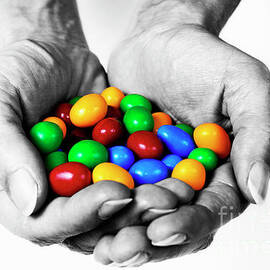 Woman holding coloured chocolate eggs by Sami Sarkis Photography