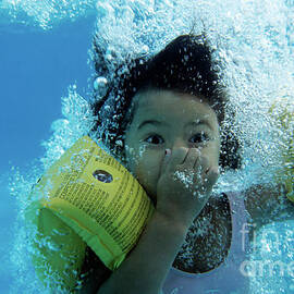 Young Girl Diving In A Swimming Pool Underwater by Sami Sarkis Photography