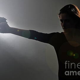 Young woman holding gun by Sami Sarkis Photography