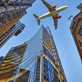  A jet plane flying over the city by Bombaert Patrick