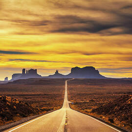 Desert road leading to Monument Valley at sunset by Miroslav Liska