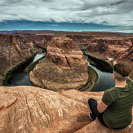 Horseshoe Bend and a hiker at the edge by Miroslav Liska