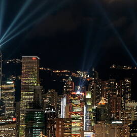 Laser show over city at night by Sami Sarkis Photography