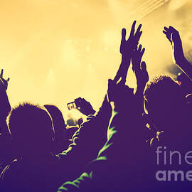 People with hands up in night club by Michal Bednarek