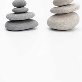 Two stacks of white and gray pebbles by Sami Sarkis Photography