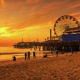 Visitors enjoy sunset above Santa Monica Pier in Los Angeles by Miroslav Liska