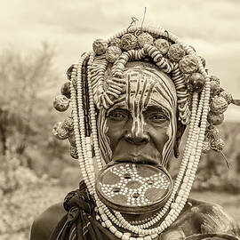 Woman from the african tribe Mursi in her village by Miroslav Liska