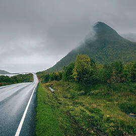 Scenic road along the coastline in Norway on a rainy and foggy day by Miroslav Liska